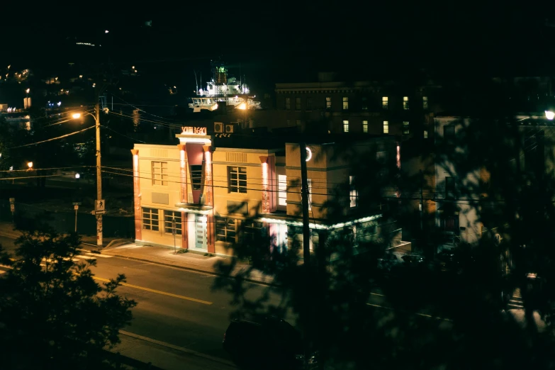 a large building on a street side at night