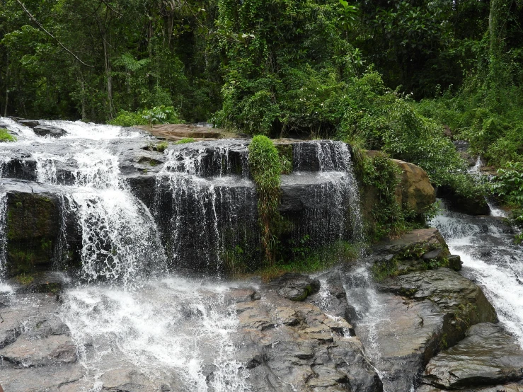 waterfall with a river, greenery and rocks