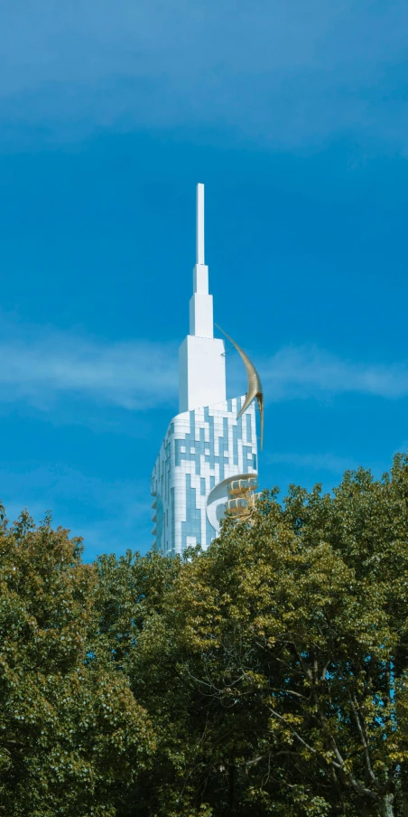 trees surround a tower shaped structure that looks like it is on top of the building