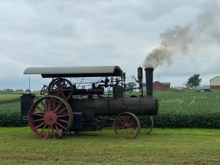 an old train is sitting out on the grass