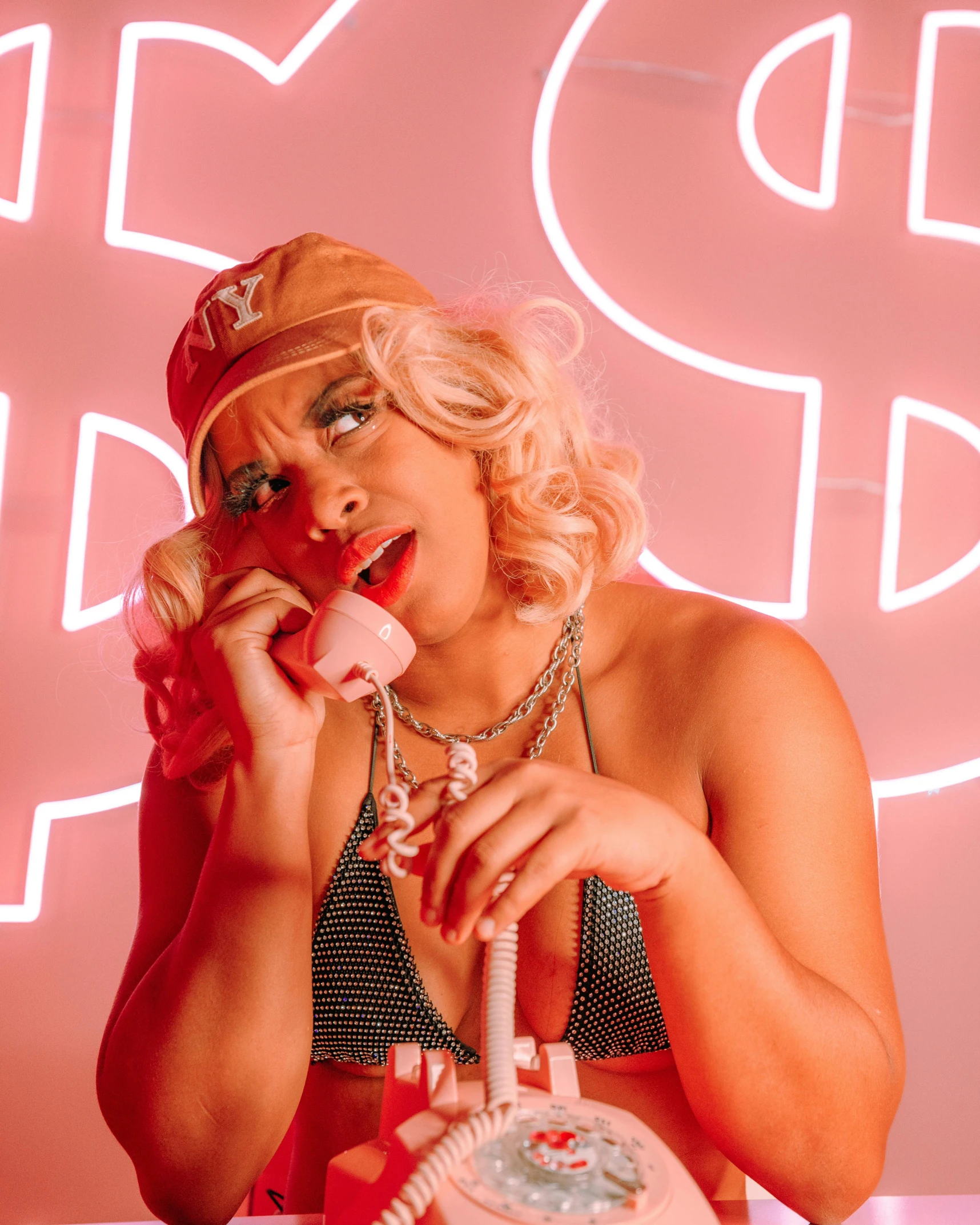 a woman holds an old fashioned telephone up to her ear