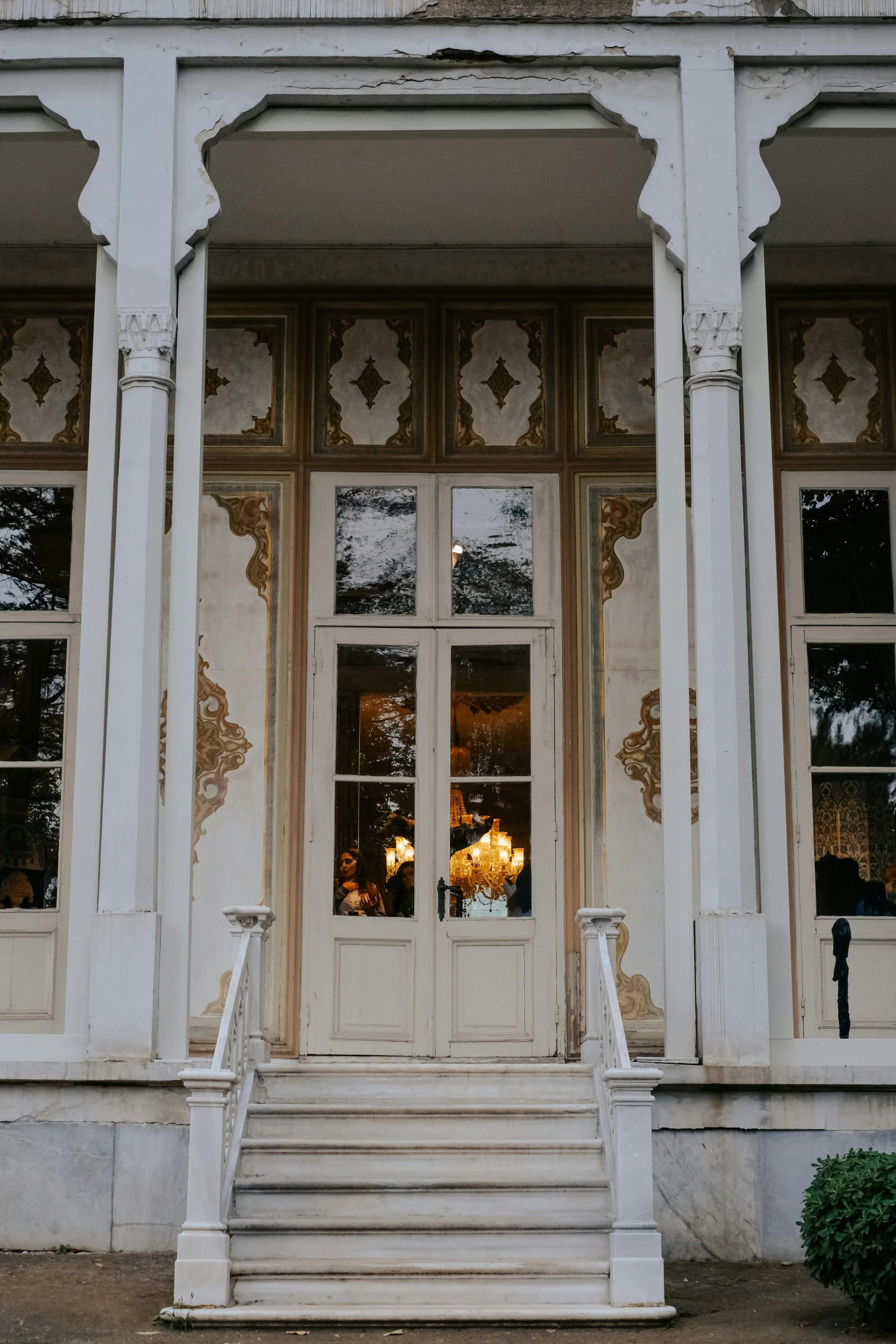 an outside view of the doorways and steps of a church