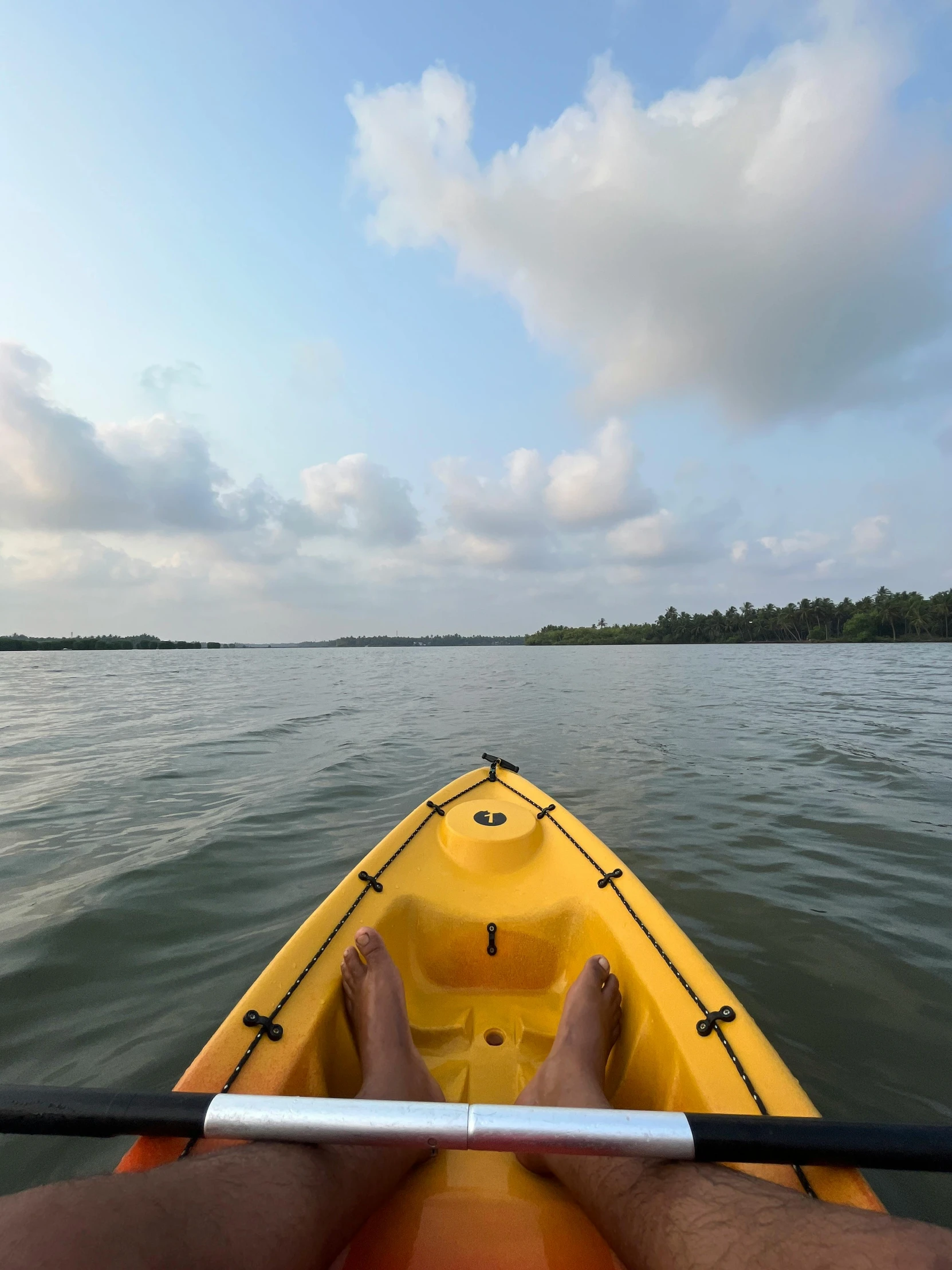 someone's legs in a kayak floating in the water