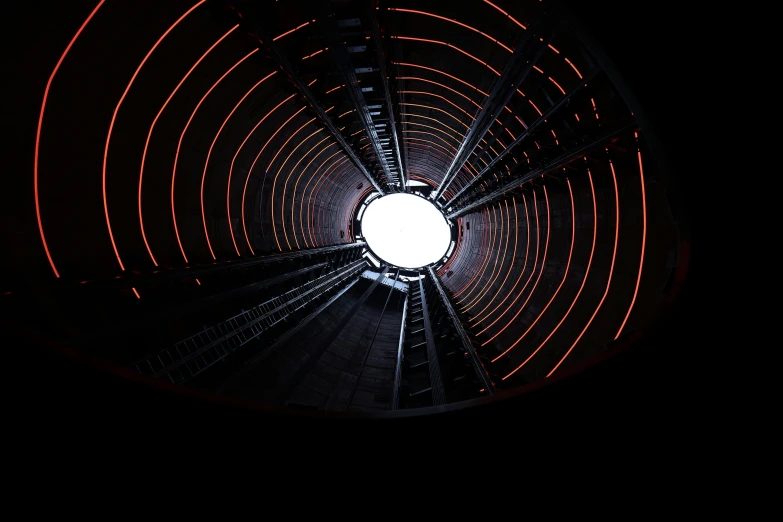 view from the ground of a spiral shape structure in the dark