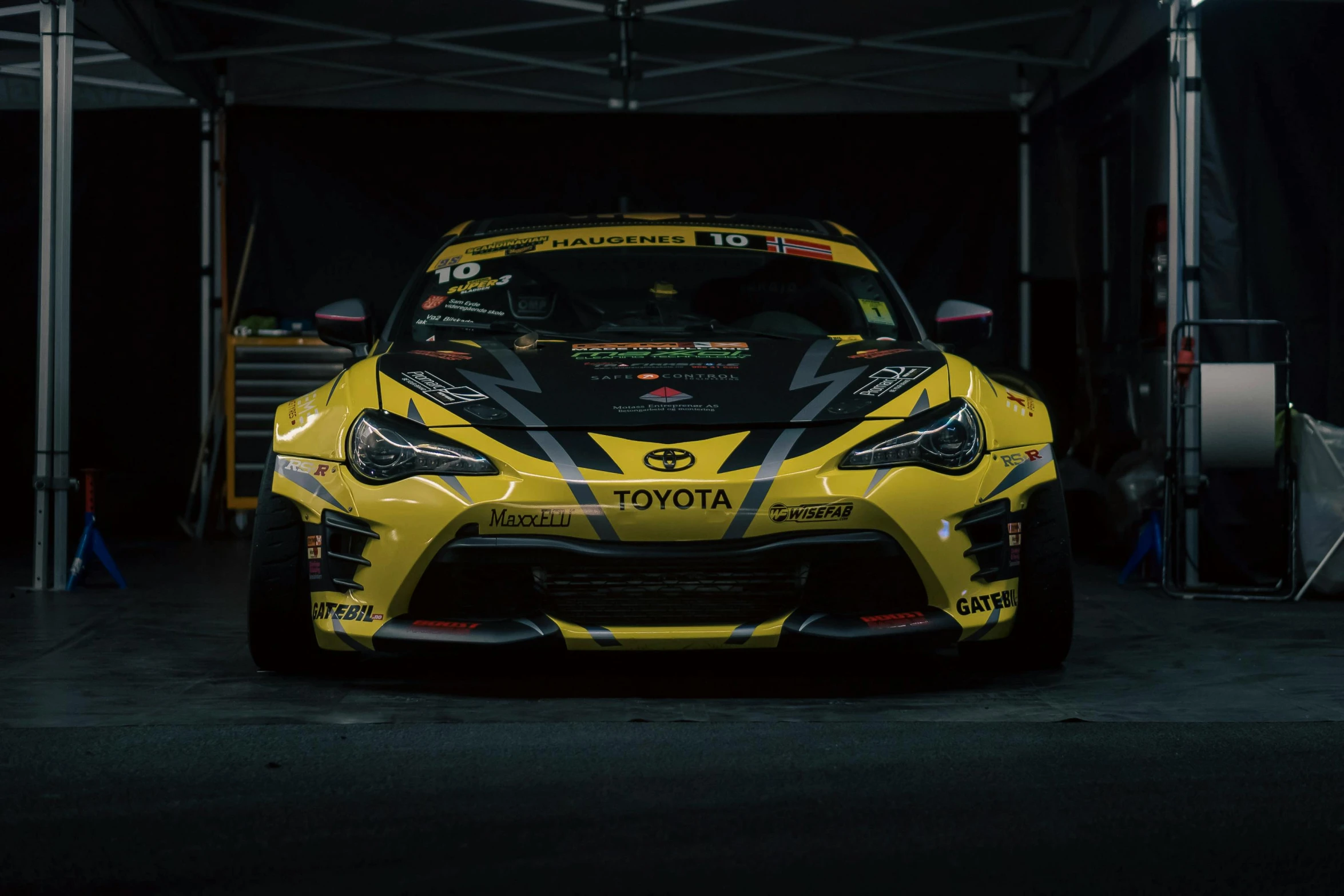 a yellow sports car is sitting inside a building