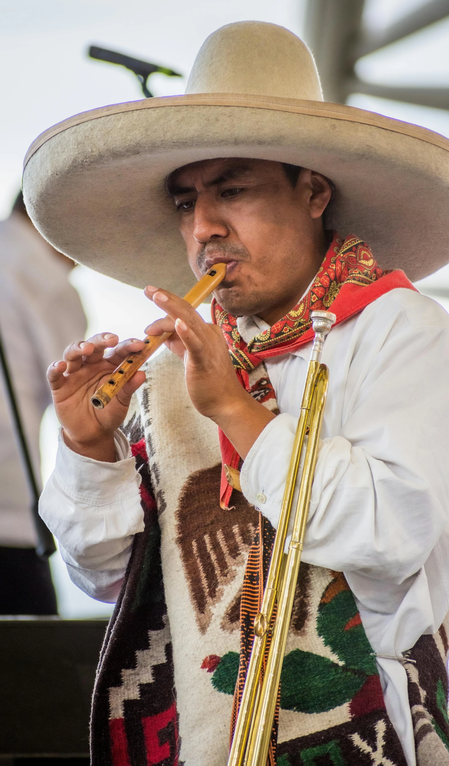 a person wearing a sombrero playing a pipe