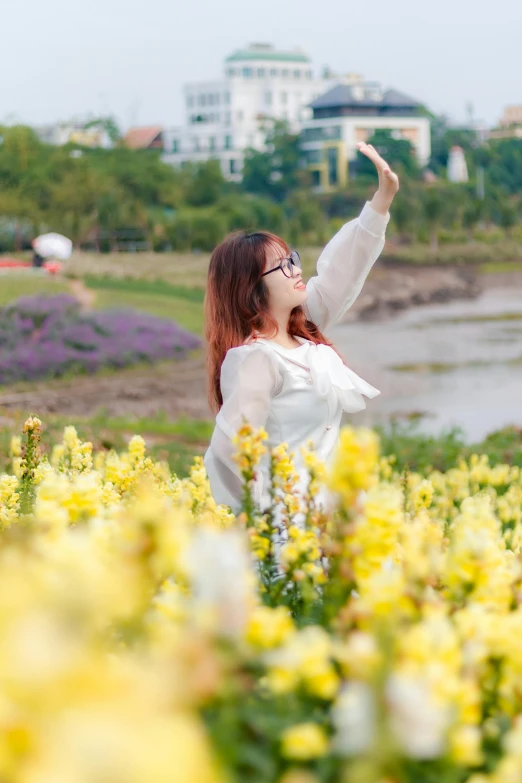 a woman looking up at the sky and waving