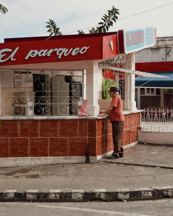 a person stands outside a small restaurant