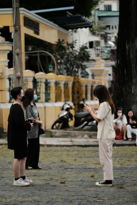 some people outside on the ground and one is standing up