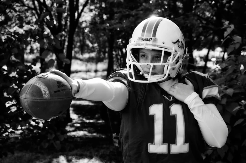 a young man in uniform with a football