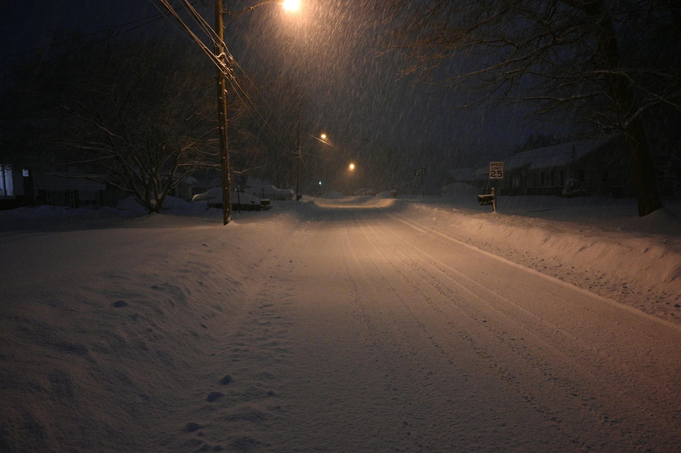 a street is lined with snow at night