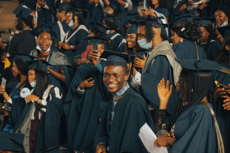 a group of graduates, with each wearing a large black cap and gown