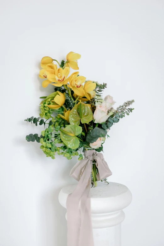 a bouquet of yellow flowers sitting on top of a vase