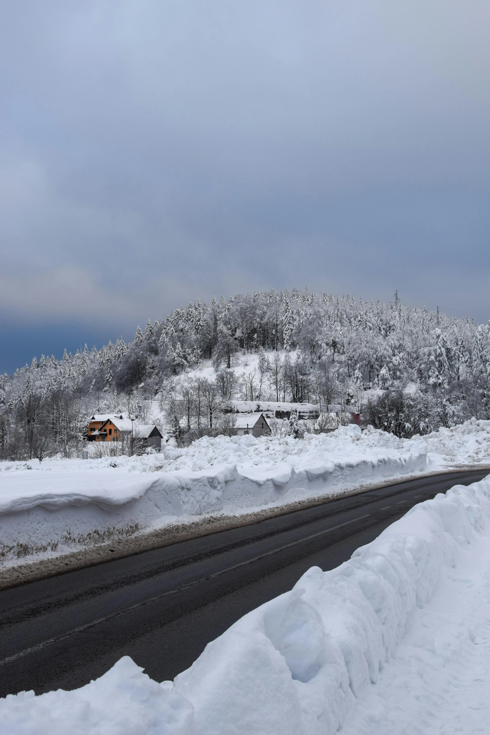 a snowy street next to a road covered in snow