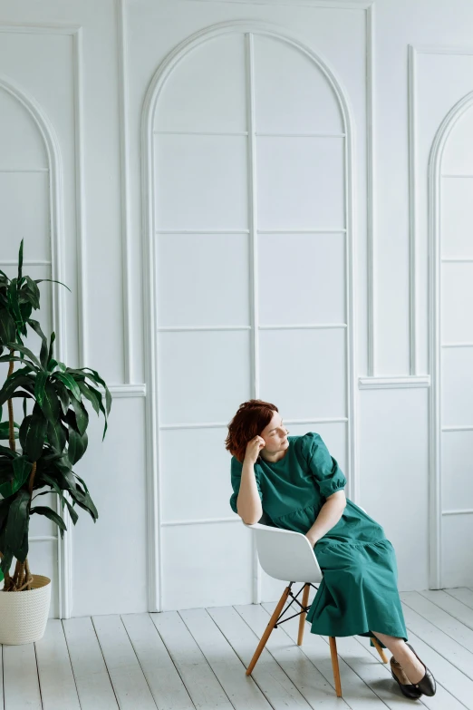 a woman sitting on a chair in an empty room