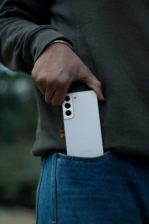 a white remote control sitting in the pocket of a person