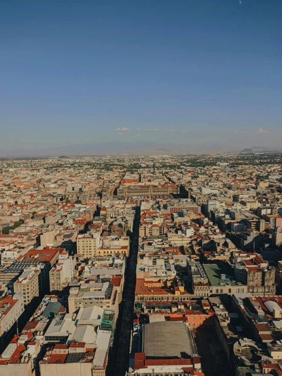 an aerial view of a city with buildings and blue sky