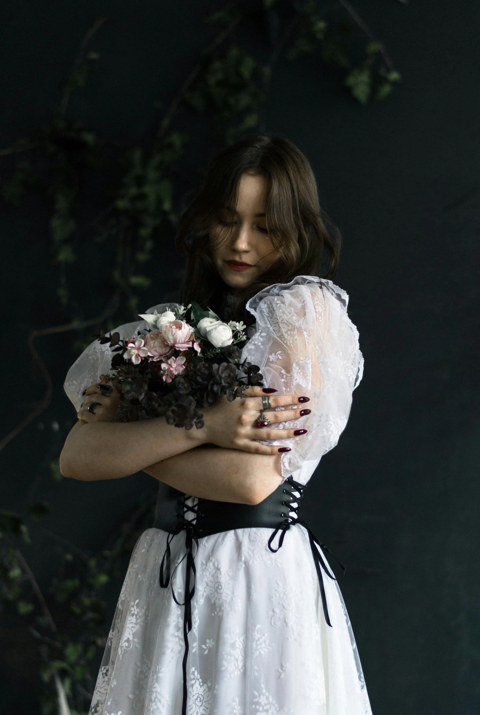 a woman in a white dress and flower bouquet