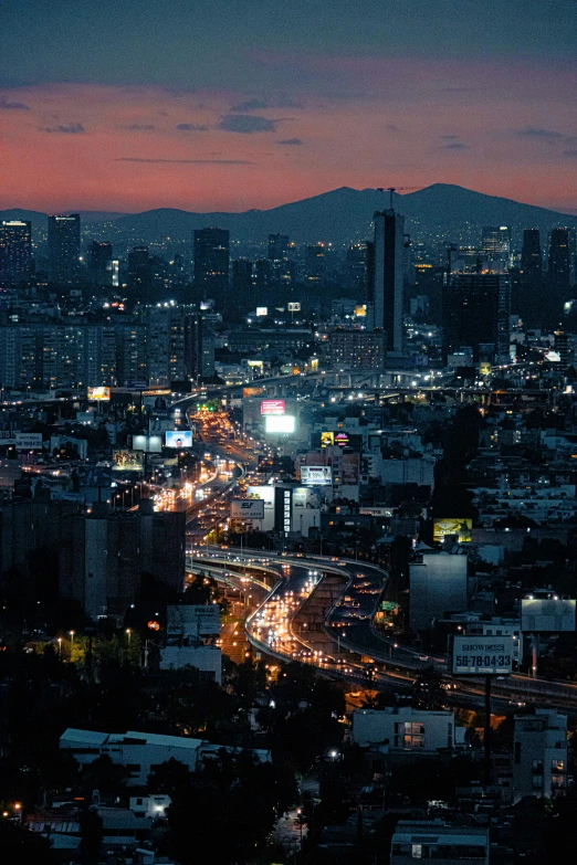 a view from above of cityscape and mountains with lights at night