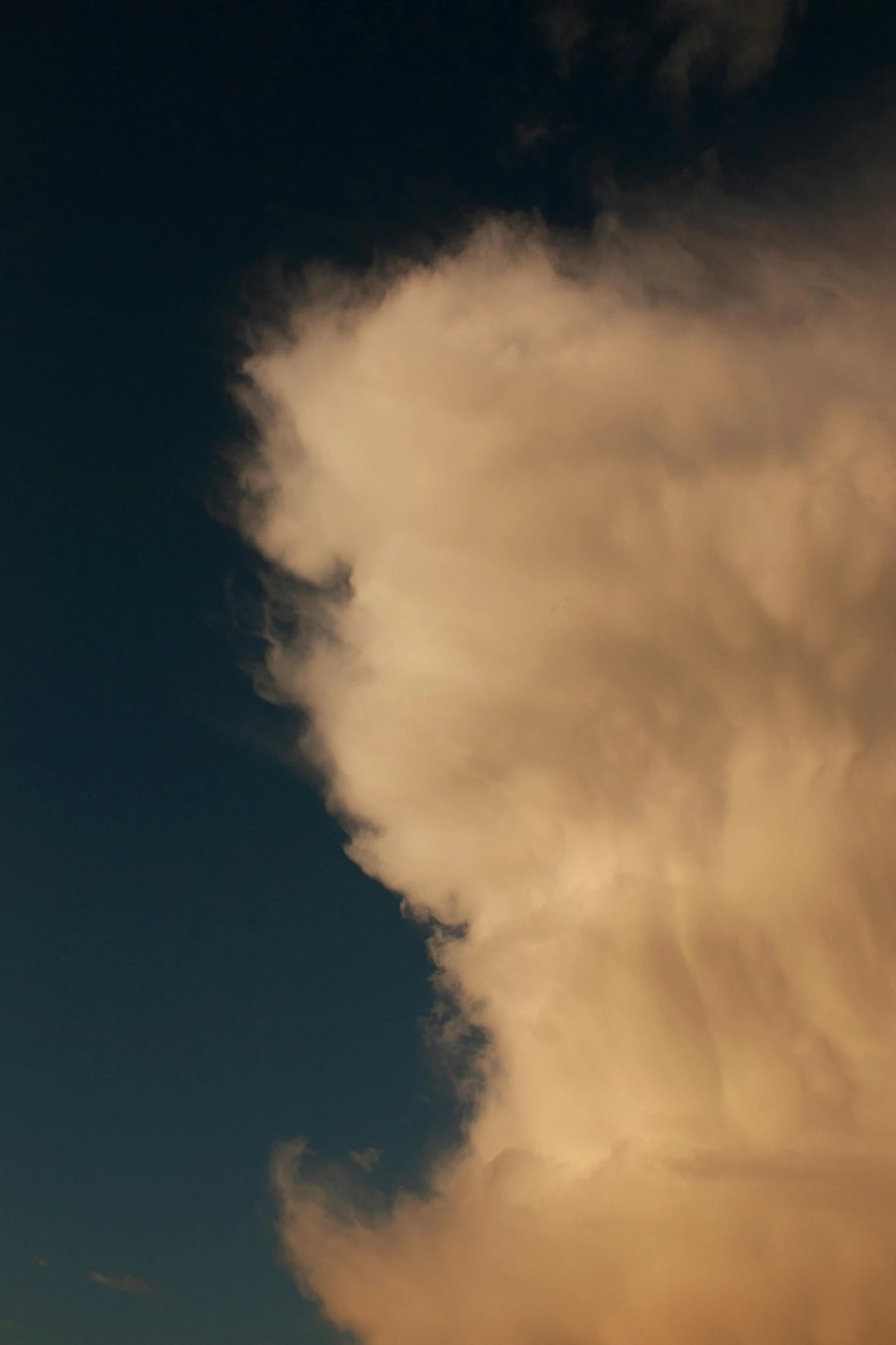 a plane flying through a cloudy blue sky