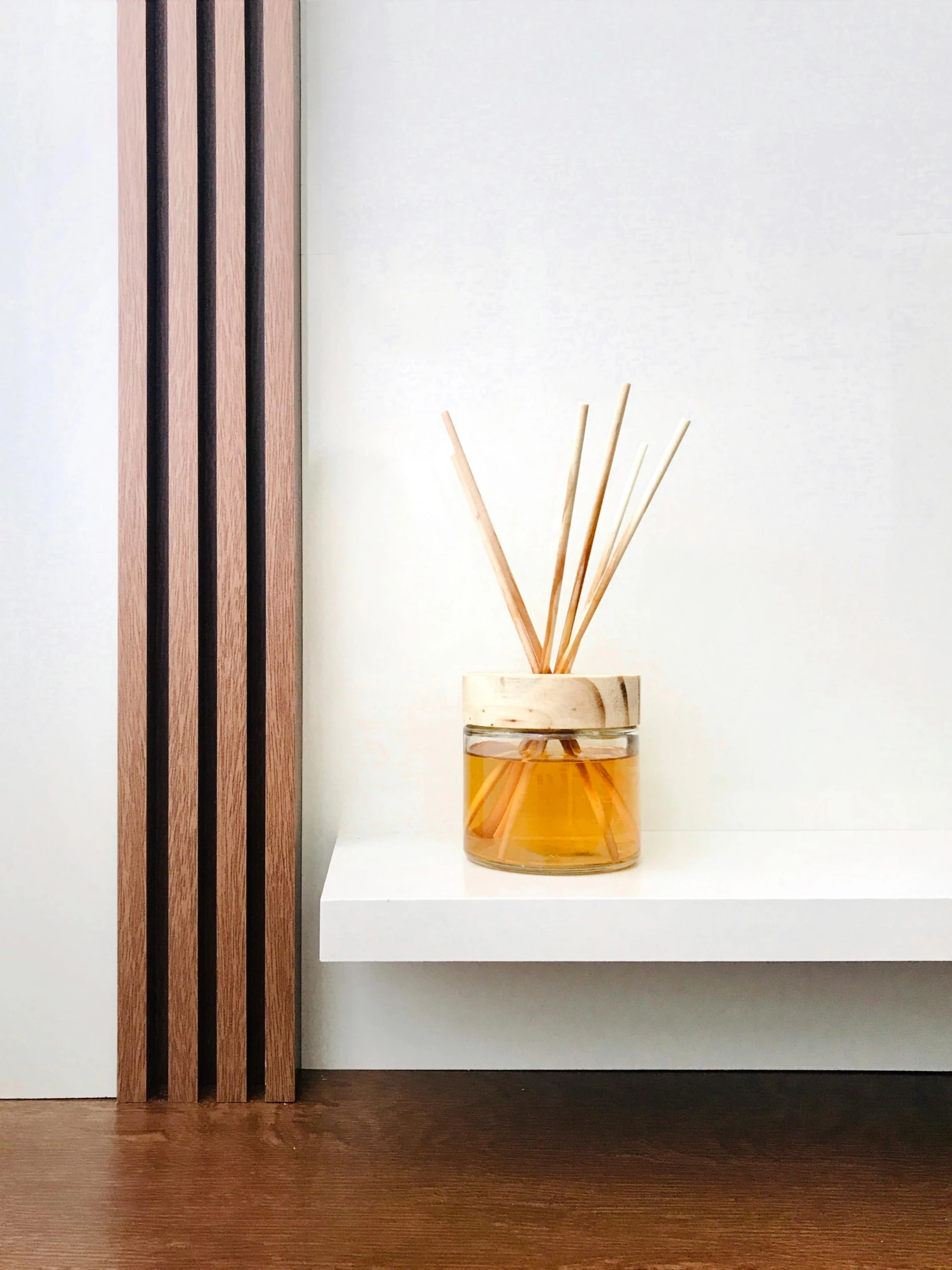 a wooden pipe sitting in front of a bottle filled with liquid