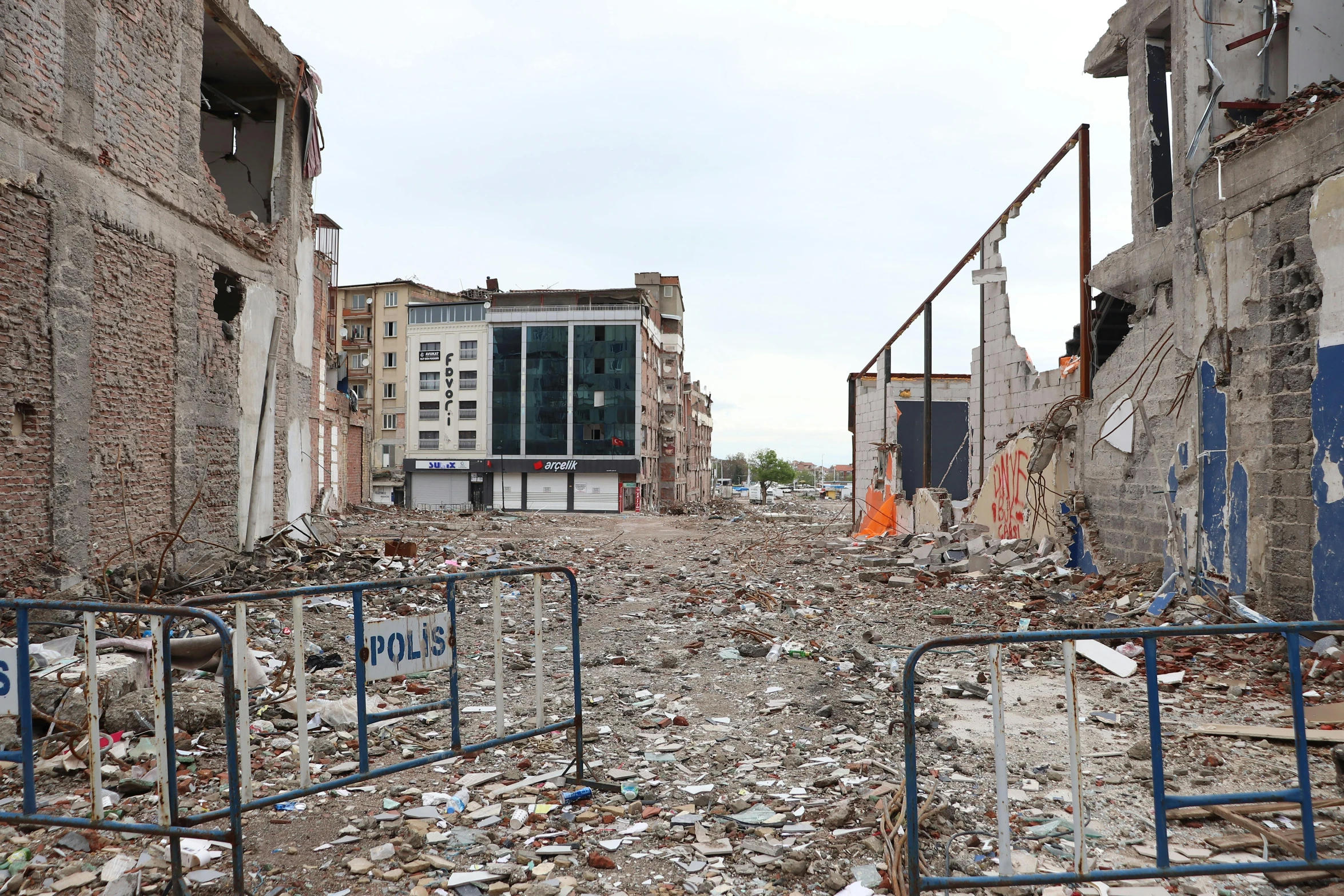 many trash is strewn everywhere between several buildings