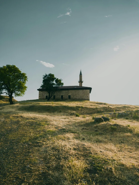 a small house on top of a hill