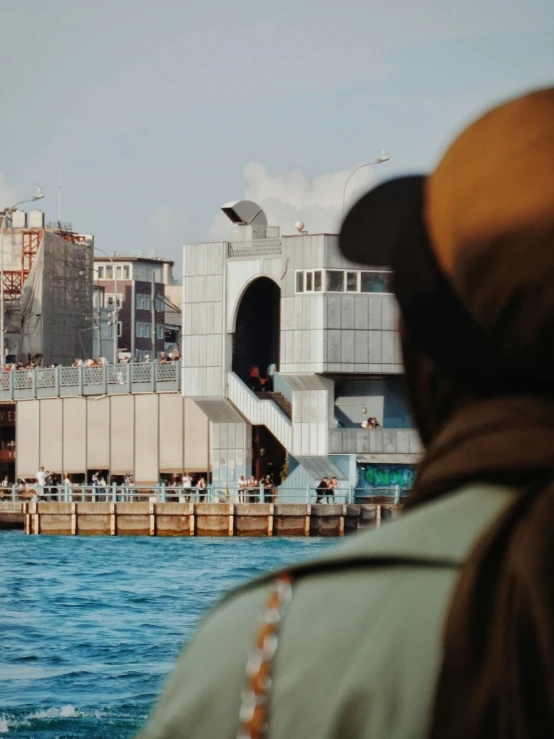 a man staring at the city from a boat