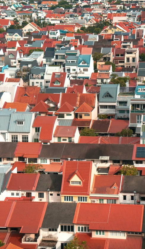 a row of houses with orange tiled roofs and chimneys