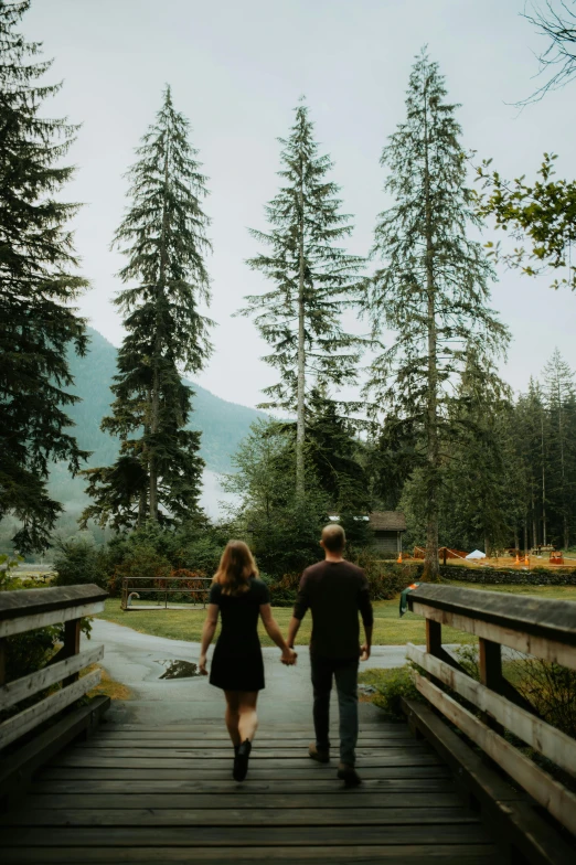 a man and a woman are holding hands and walking together