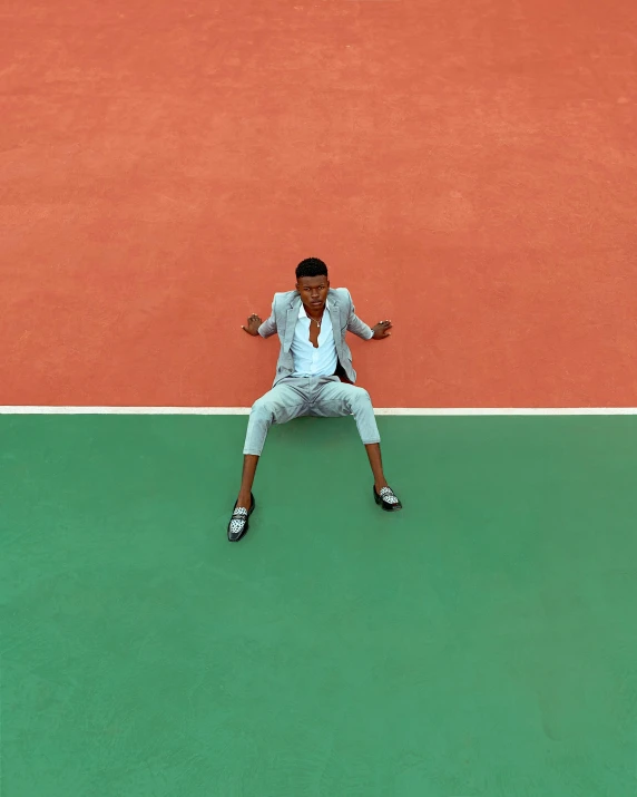 a tennis player with a racket is holding his arm out in triumph