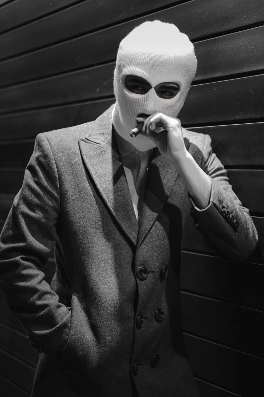 man wearing a suit and mask in a black and white image