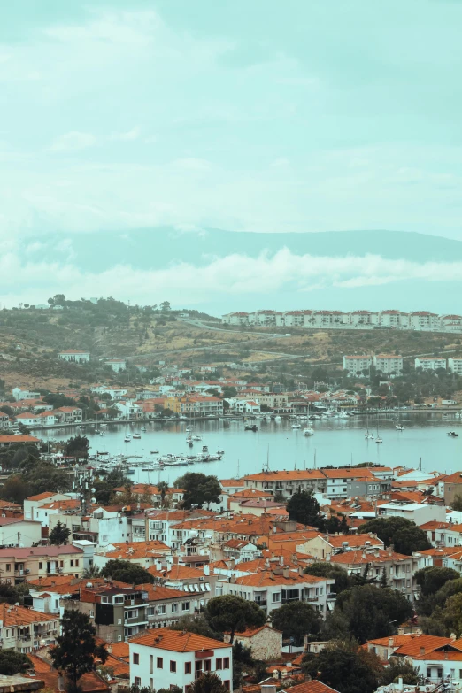 the view from the hill overlooking a town with orange roofs