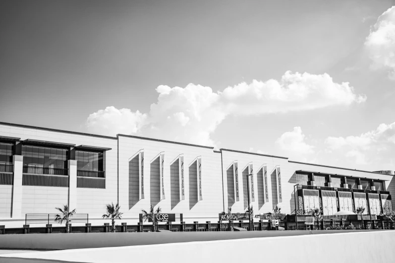 a large building with benches and tables in front of it