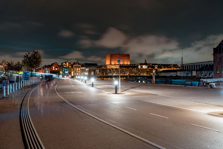 a city street at night with tall buildings