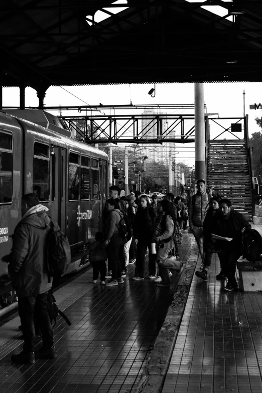 several people wait to board the subway train