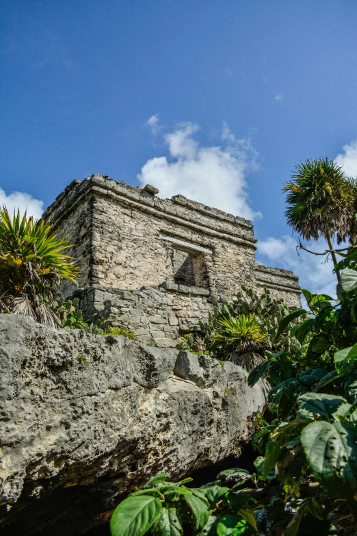 an old stone building nestled on a rock outcropping