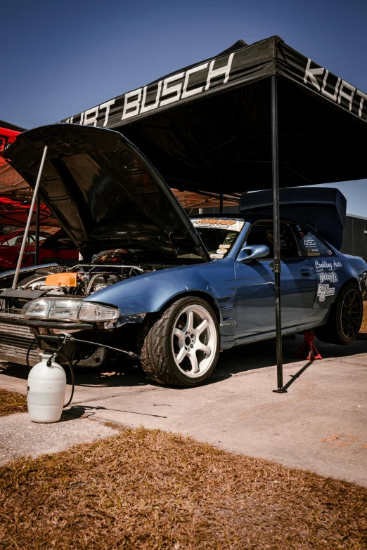 the undercarriage of a car is covered with a shade cloth