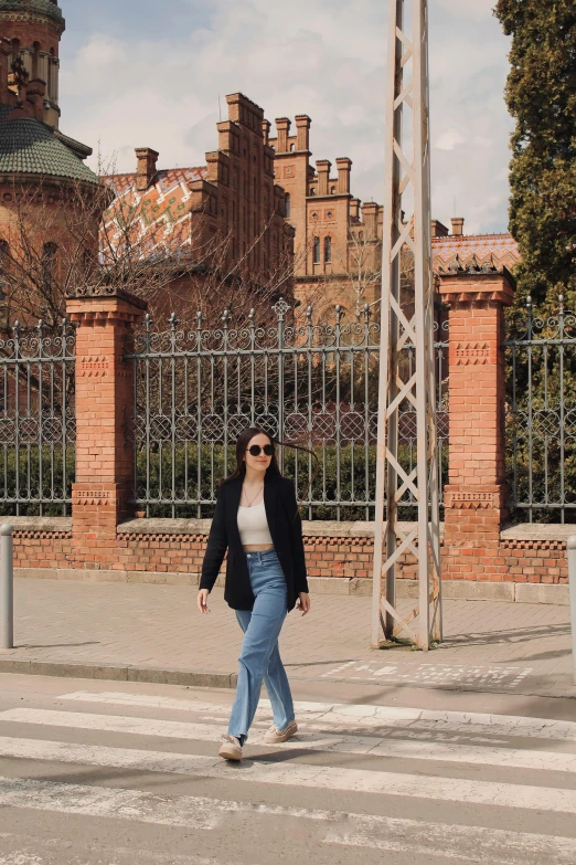 a woman crossing a cross walk at a crosswalk