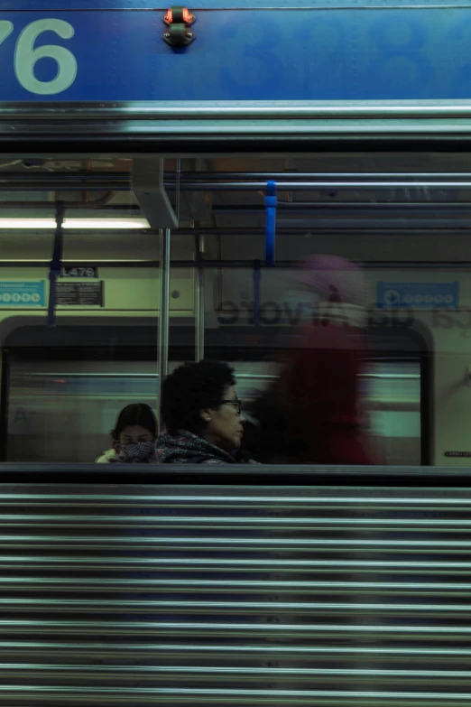 a passenger car with people inside sitting on a train