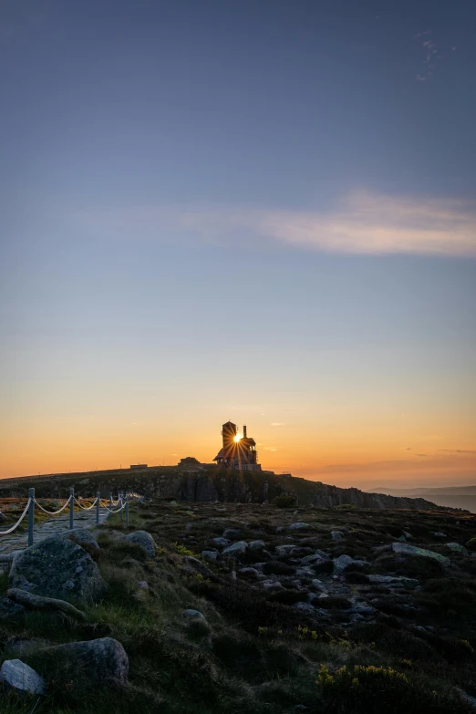 people are sitting at a table on top of the mountain