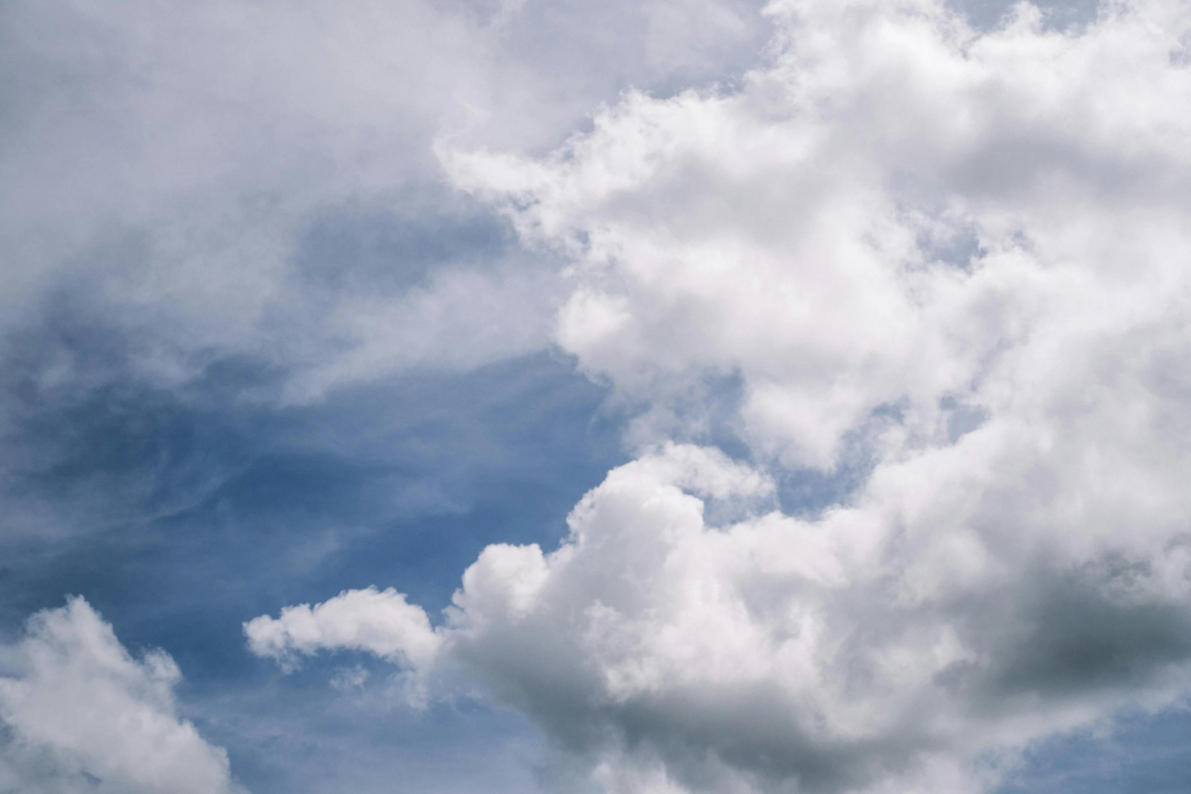 a plane flying by the sky and clouds