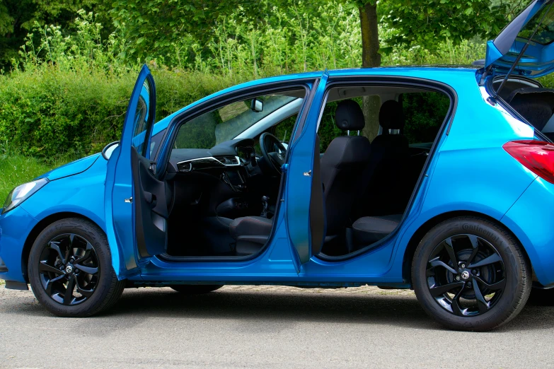 a small blue car with its door open
