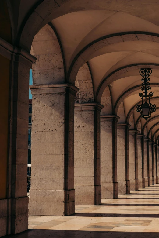 large arches line the concrete sides of a stone - lined building