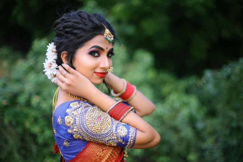 a woman wearing some jewelry and a ring