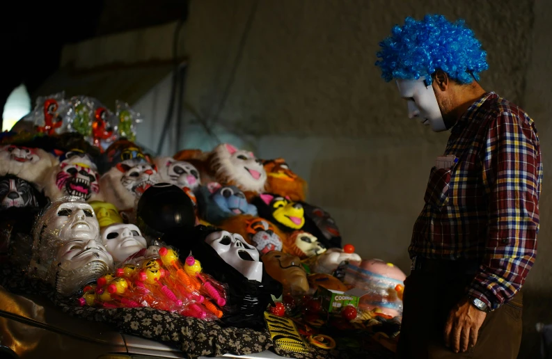 there is a man with blue hair and masks on the street