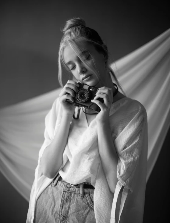 a woman holds her camera up to her face