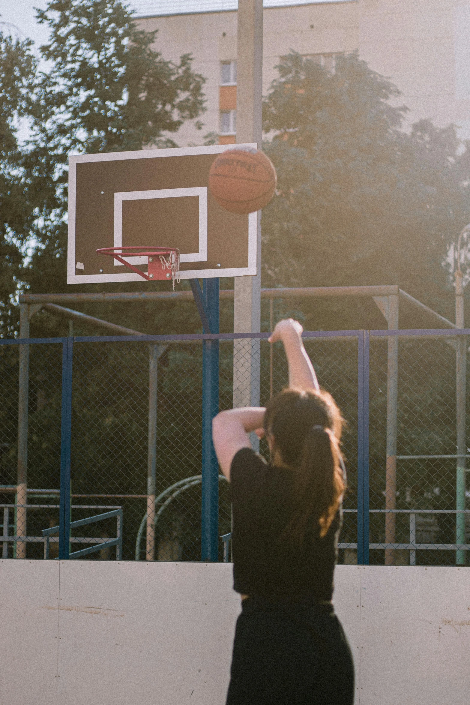 a man and woman playing basketball on the court