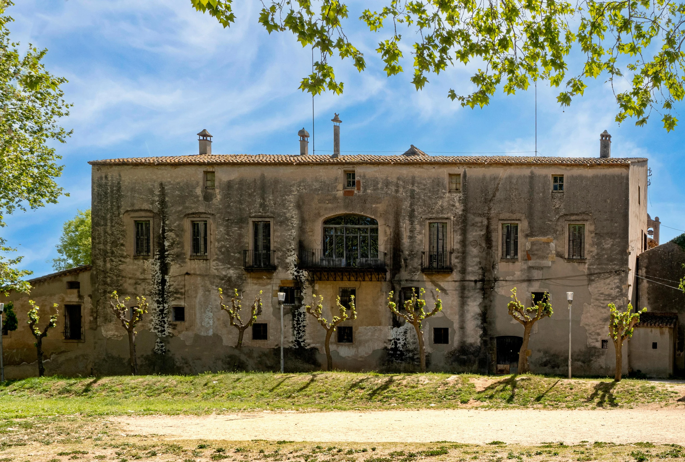 a building with a bunch of windows and grass