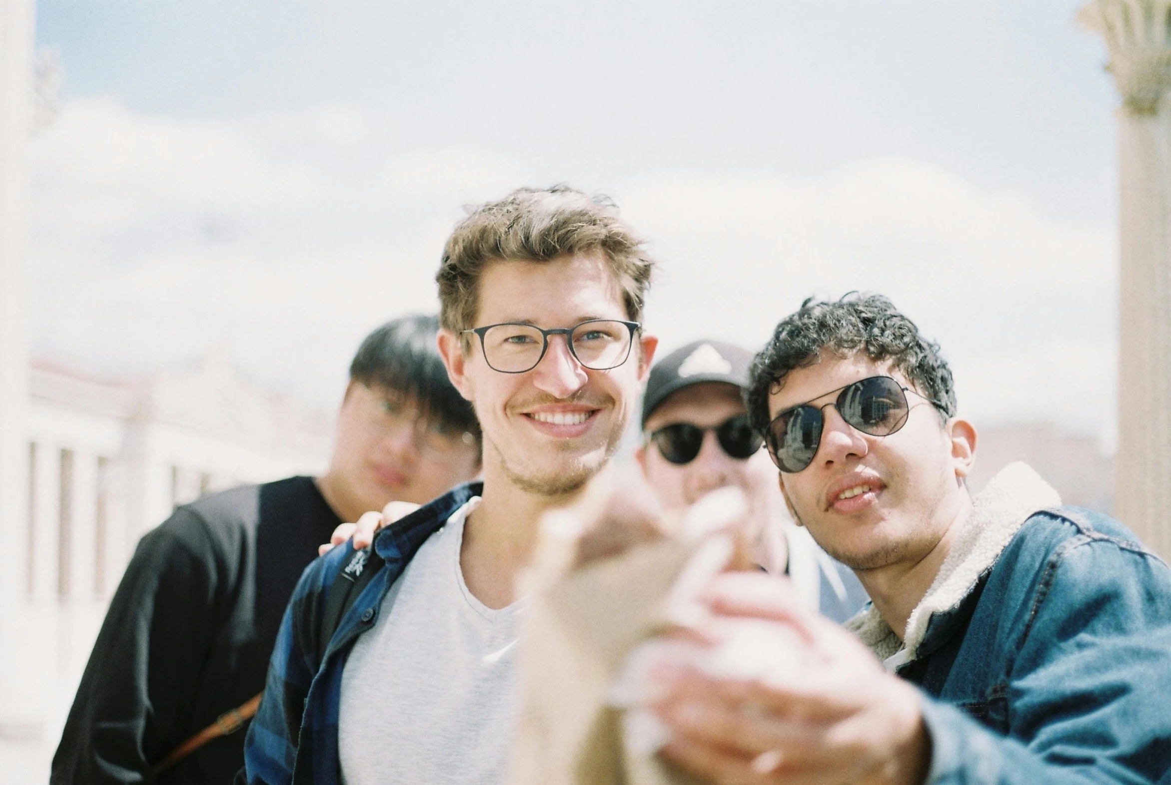 two young men taking pictures with their cameras